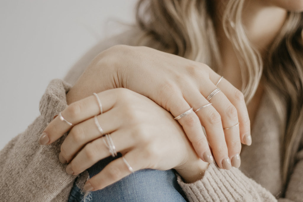 Woman wearing minimalist handmade sterling silver stacking rings