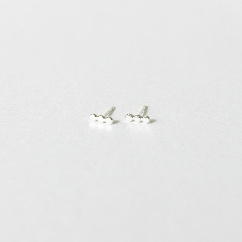 sterling silver stud earrings on a white surface