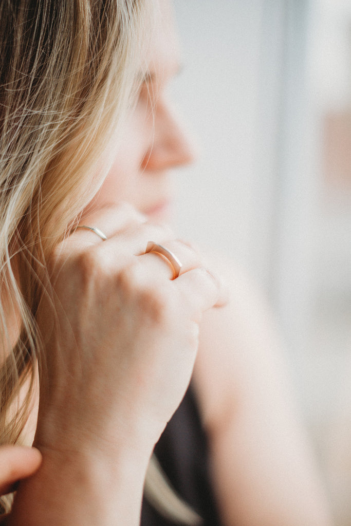 Woman wearing minimalist, handcrafted sterling silver statement ring