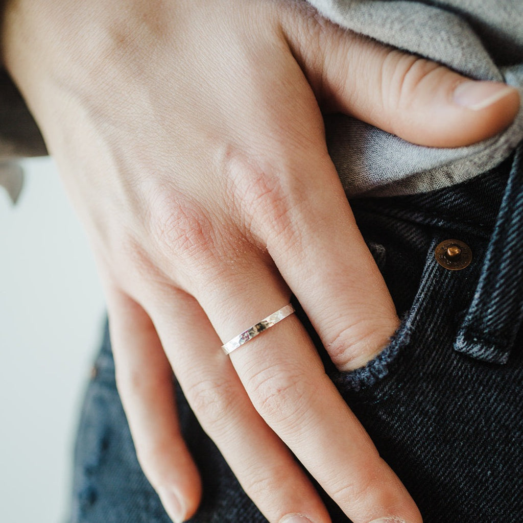 Sterling Silver 2.5mm band with a hammered texture on a woman's hand