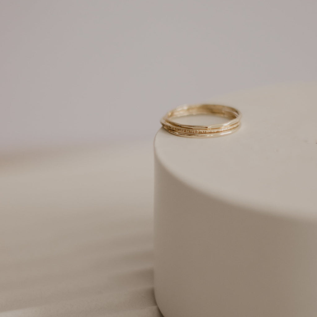Minimalist handmade 14k solid gold stacking rings with in a smooth birch and faceted texture