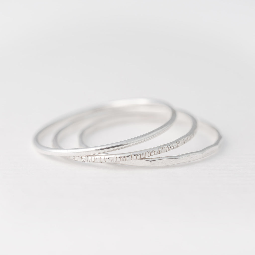 Minimalist handmade sterling silver stacking rings with in a smooth birch and faceted texture