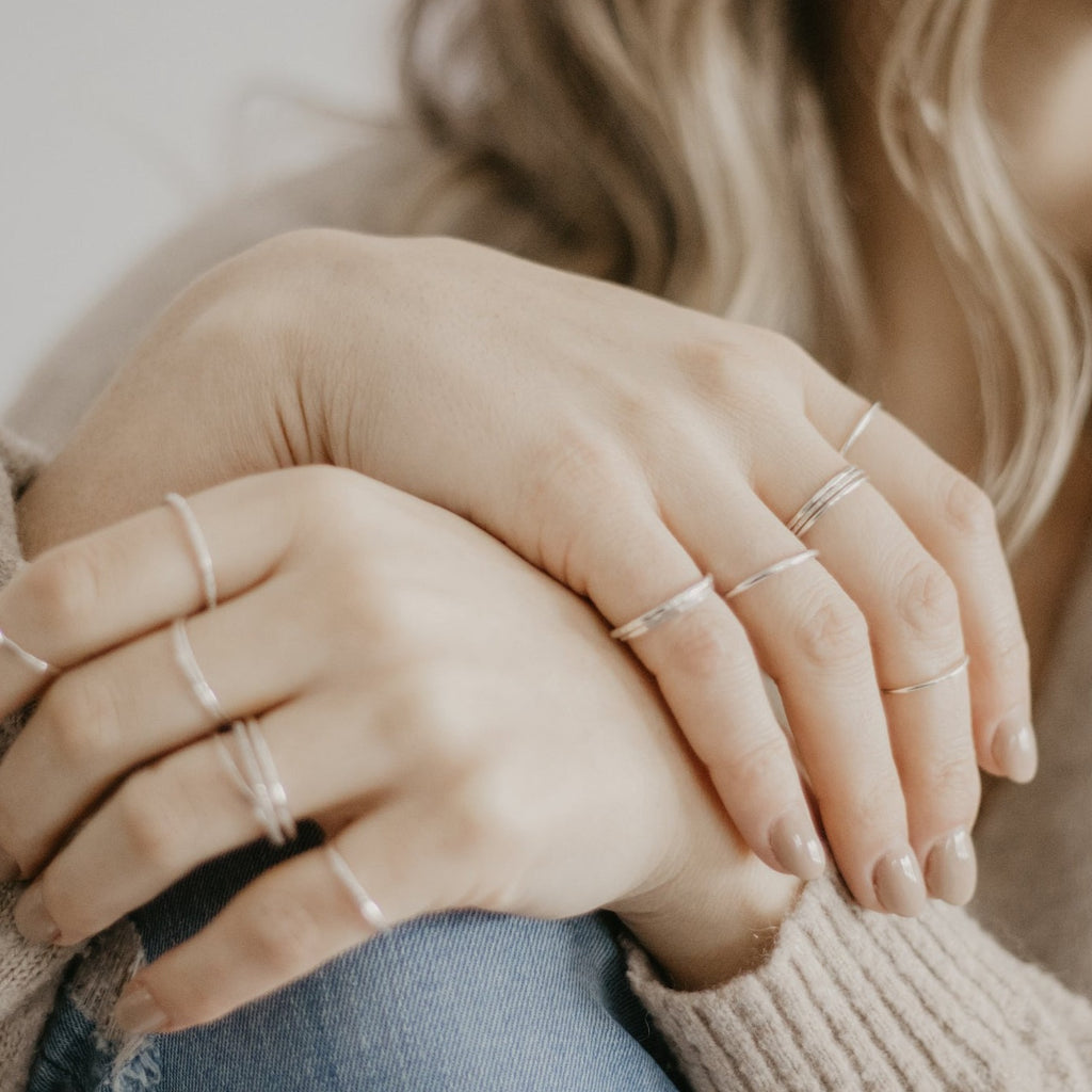 Woman wearing minimalist handmade sterling silver stacking rings