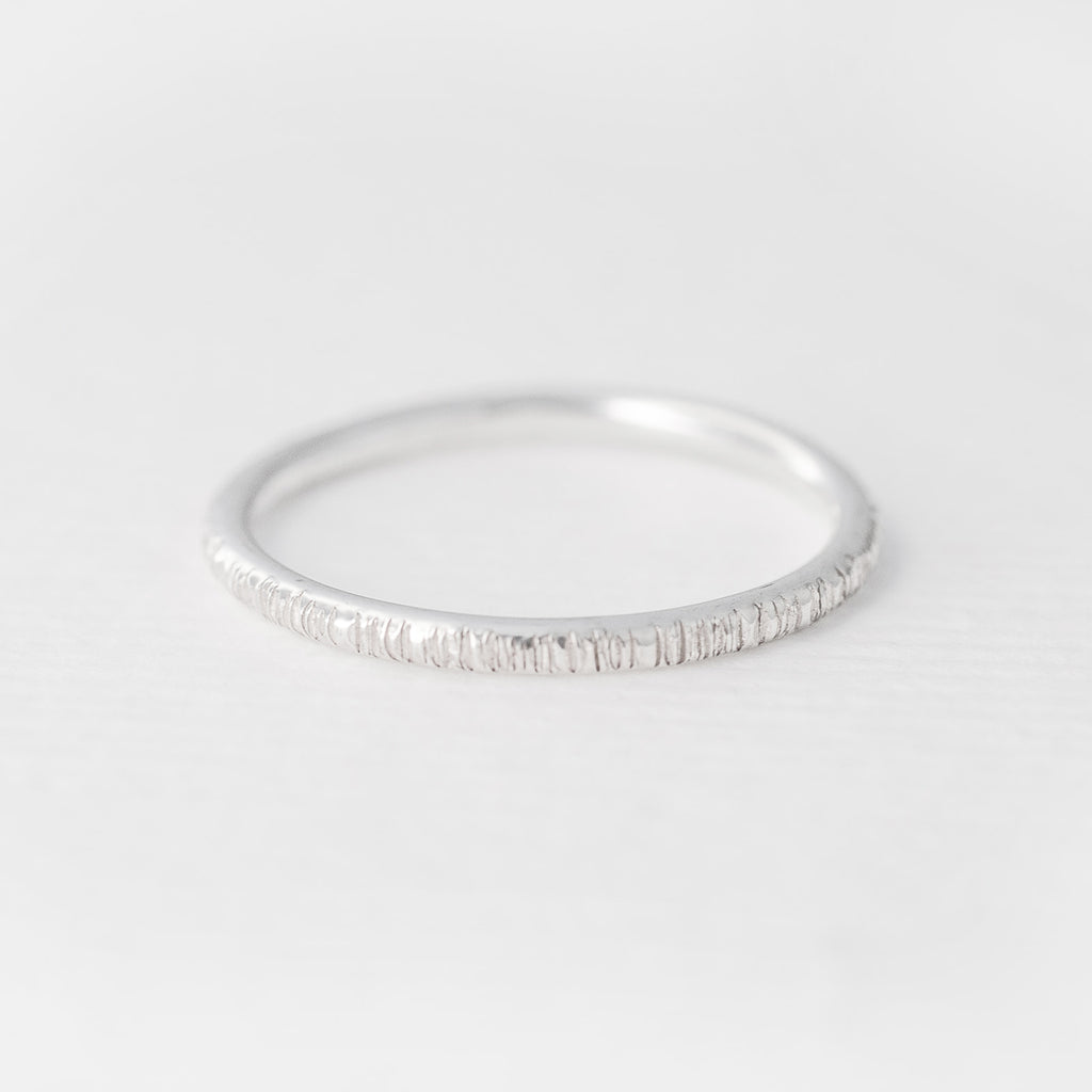 Minimalist handmade sterling silver stacking ring in a birch texture